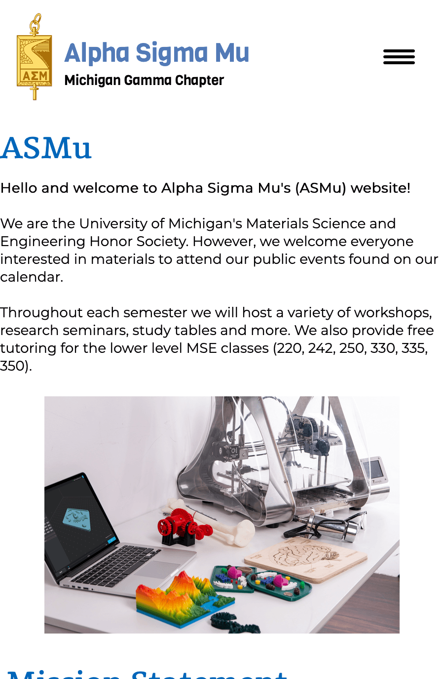Website landing page of ASMu shows a navigation bar, a title, and an image of a computer with scientific objects around it.