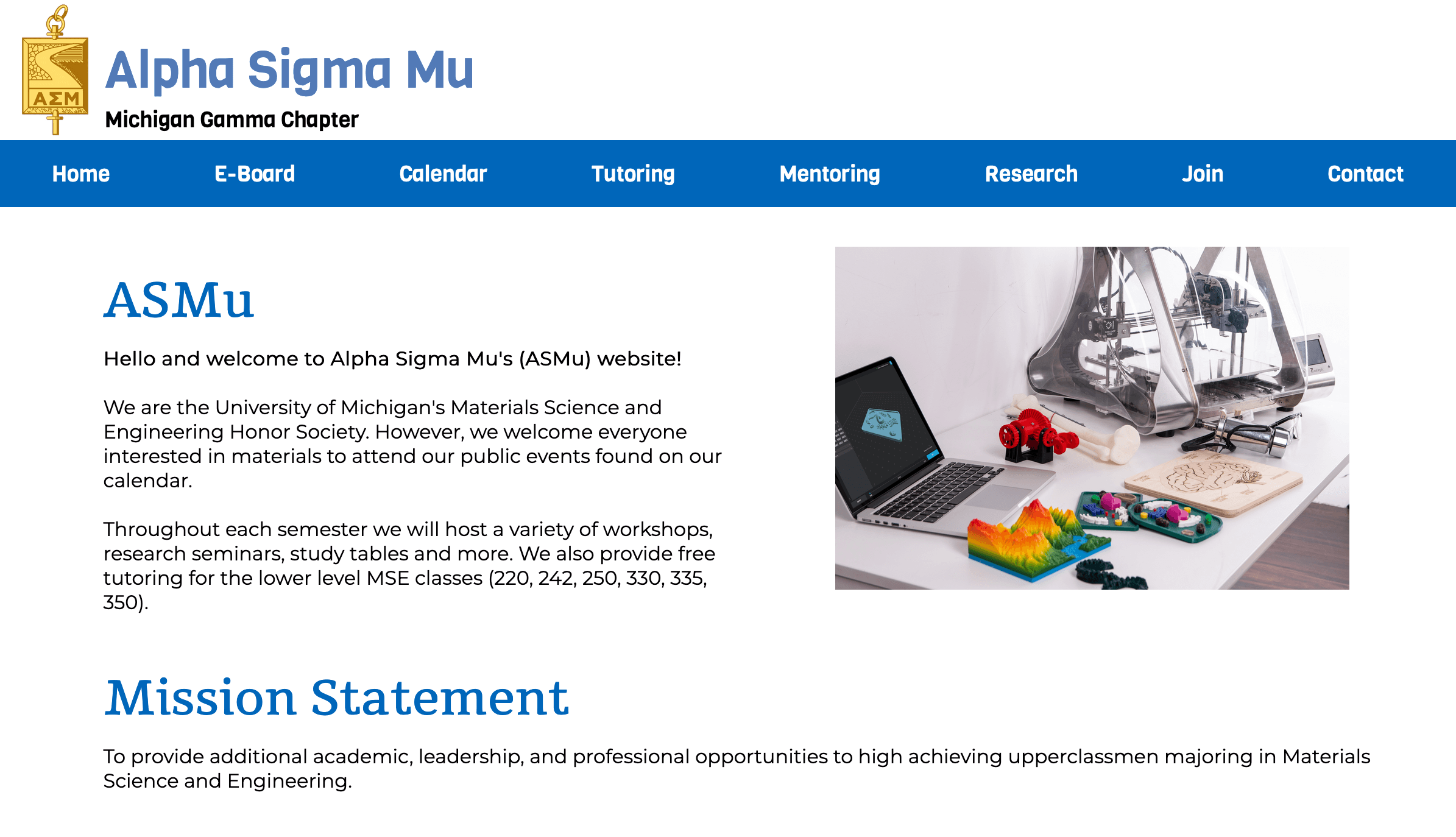 Website landing page of ASMu shows a navigation bar, a title, and an image of a computer with scientific objects around it.